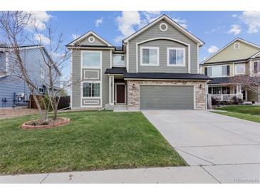 Charming two-story home with a well-manicured lawn and attached two-car garage at 134 Laramie Ct, Castle Rock, CO 80104