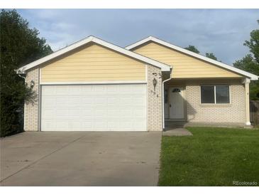 Charming single-Gathering home featuring a spacious two-car garage and well-maintained front yard at 894 S Krameria St, Denver, CO 80224