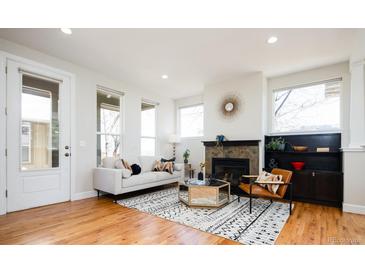 Bright living room features hardwood floors, a fireplace, and abundant natural light at 452 N Finch Ave # 452B, Lafayette, CO 80026
