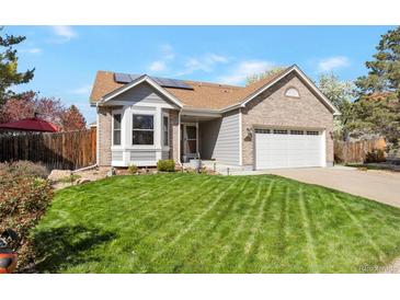 Charming single-Gathering home showcasing a well-manicured lawn, complemented by a brick and gray color scheme at 2533 W 110Th Ave, Westminster, CO 80234