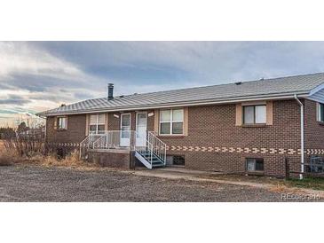 Quaint brick home featuring dual front entryways and a well-maintained roof at 15800-15802 E 11Th Ave, Aurora, CO 80011