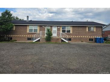 Brick home with two entry doors, white stairs, and a newly installed dark roof at 15800-15802 E 11Th Ave, Aurora, CO 80011