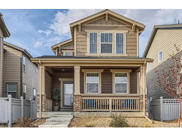 Charming two-story home with a welcoming front porch and tasteful exterior details at 18809 E 66Th Ave, Denver, CO 80249