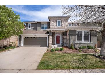 Charming two-story home with a well-maintained front yard, stone accents, and an attached two-car garage at 2749 Pemberly Ave, Highlands Ranch, CO 80126