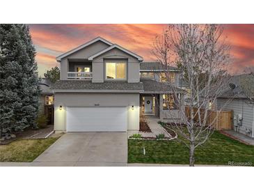 Charming two-story home boasts a well-manicured lawn and attached two-car garage, creating instant curb appeal at 5640 S Marshall St, Denver, CO 80123