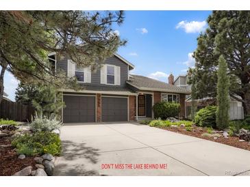 Charming two-story home with a well-maintained front yard and a two-car garage at 7955 S Bemis St, Littleton, CO 80120
