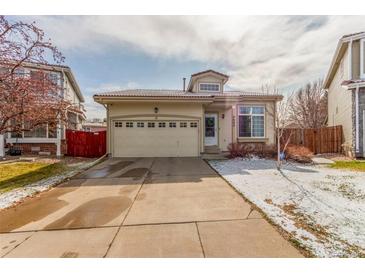 Charming single Gathering home featuring an attached two car garage, and manicured front yard at 4602 Genoa St, Denver, CO 80249