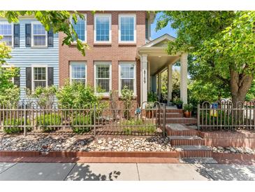 Charming brick home with a landscaped front yard and inviting front porch at 8189 E 29Th Ave, Denver, CO 80238