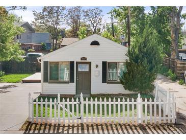 Charming home featuring a white picket fence and well-manicured landscaping at 3925 Pecos St, Denver, CO 80211