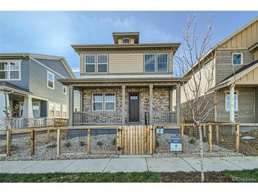 Charming two-story home features a welcoming front porch and a fenced yard at 2682 E 103Rd Ave, Thornton, CO 80229