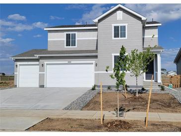 Charming two-story home boasts a two-car garage, neutral siding, and a well-manicured front yard, perfect for suburban living at 14412 Heritage Dr, Mead, CO 80504