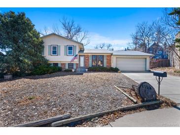 Charming split-level home with brick and siding, a well-manicured lawn, and an attached two-car garage at 2154 S Joplin Way, Aurora, CO 80013