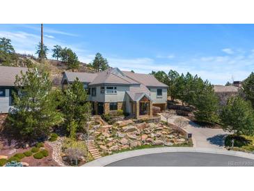 Elegant two-story home showcasing beautiful rock landscaping and a private driveway at 4788 Silver Pine Dr, Castle Rock, CO 80108