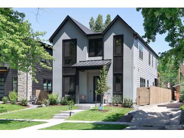 Contemporary two-story home featuring a well-manicured lawn and modern architectural details at 3149 W 35Th Ave, Denver, CO 80211