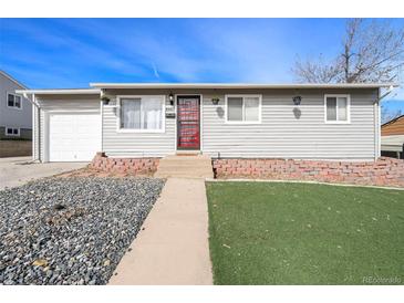 Charming single-story home with gray siding, updated windows, well-maintained landscaping, and a red front door at 8441 Mcdougal St, Denver, CO 80229