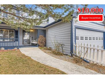 Charming two-story home with a front porch swing and a well-manicured lawn featuring $10,000 buyer incentive at 7729 Beverly Blvd, Castle Pines, CO 80108