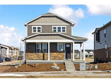 Charming two-story home with stone accents, covered porch and a well-maintained yard in a quiet neighborhood at 28640 E 8Th Pl, Watkins, CO 80137