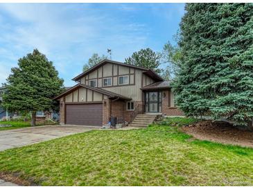 Charming two-story home with a well-maintained front yard and attached two-car garage at 17390 E Greenwood Cir, Aurora, CO 80013