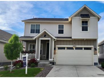 Two-story home with a two-car garage, a covered front porch, and a well-maintained landscaped yard at 27857 E 8Th Ave, Aurora, CO 80018