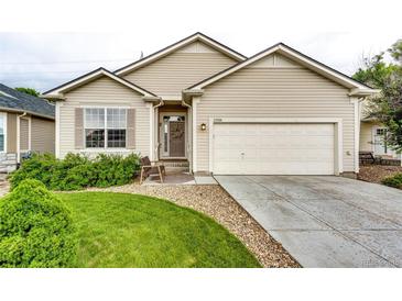 Charming single-story home with manicured lawn, covered entry, and attached two-car garage at 22026 Hill Gail Way, Parker, CO 80138