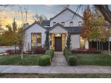 Charming two-story home with a walkway, manicured lawn, and tasteful landscaping at 1291 S Gaylord St, Denver, CO 80210
