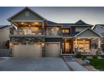Charming two-story home featuring a spacious three-car garage and inviting front porch at 4965 Malaya St, Denver, CO 80249