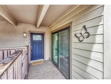 Welcome to this home featuring a secure front door with a glass pane window and a neutral-toned welcome mat at 2525 S Dayton Way # 2209, Denver, CO 80231