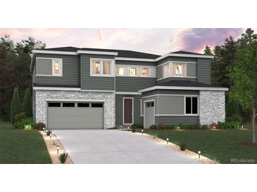 Modern two-story home with stone accents, a two-car garage, and manicured landscaping at 1784 Morgan Dr, Erie, CO 80516