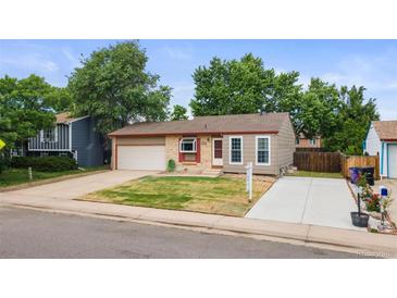 Charming single-Gathering home featuring a manicured front lawn and attached one car garage at 5167 Sable St, Denver, CO 80239