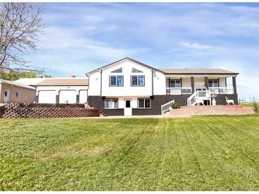 Charming two-story home features well-manicured lawn and beautiful brick accents, offering delightful curb appeal at 18553 County Road 5, Berthoud, CO 80513