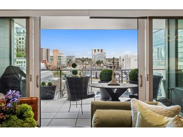 Balcony with views of the city and patio furniture at 155 Steele St # 418, Denver, CO 80206