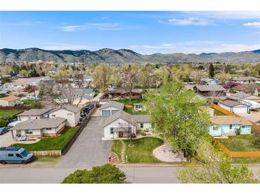Expansive aerial view showcases a charming neighborhood nestled against a stunning mountain backdrop at 1055 Quartz St, Golden, CO 80401
