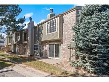 Inviting townhome with brick and siding, mature trees, and a private patio at 3407 S Ammons St # 20-1, Lakewood, CO 80227