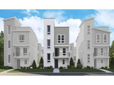 Contemporary townhome with multi-textured facade, balcony, and landscaped front yard at 1257 Rhett Dr, Erie, CO 80026