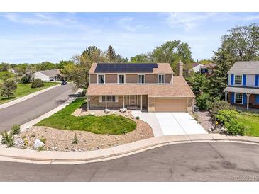 Charming two-story home with a well-manicured lawn, covered front porch and solar panels at 3298 W 11Th Avenue Pl, Broomfield, CO 80020