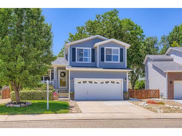 Charming two-story home with a well-maintained lawn, classic siding, and a two car garage in a suburban neighborhood at 1201 Trout Creek Cir, Longmont, CO 80504