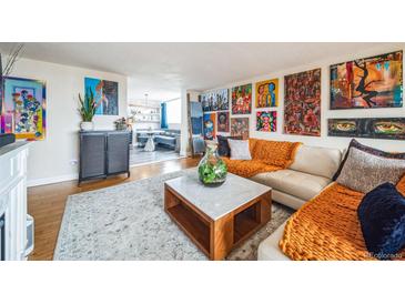 Bright living room featuring modern decor, colorful art, and cozy seating area at 1155 N Ash St # 806, Denver, CO 80220