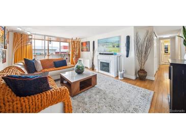 Bright and airy living room with modern fireplace and stylish decor at 1155 N Ash St # 806, Denver, CO 80220
