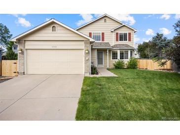 Charming two-story home with a manicured lawn and a two-car garage in a desirable neighborhood at 11100 Callaway Ct, Parker, CO 80138