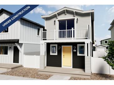 Two-story craftsman style home with balcony and yellow door at 10307 Vaughn Way, Commerce City, CO 80022