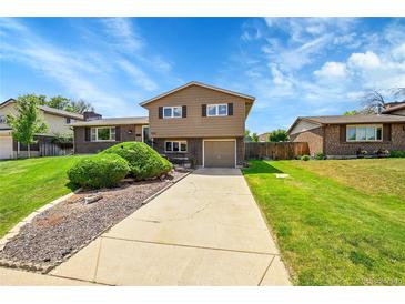 Inviting two-story home featuring neutral siding, brick accents, and a well-manicured front yard at 9225 Lowell Blvd, Westminster, CO 80031
