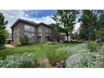 Expansive backyard with lush green lawn, mature landscaping, and patio area, perfect for outdoor living at 6584 S Sedalia St, Aurora, CO 80016