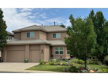 Charming two-story home with a neutral color scheme, well-maintained lawn and three car garage at 6584 S Sedalia St, Aurora, CO 80016