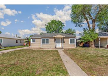 Charming single-story home featuring a well-maintained lawn and a welcoming walkway to the front door at 1023 S Alcott St, Denver, CO 80219