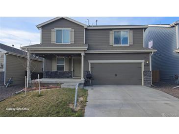 Charming two-story home with a two car garage, covered porch and easy to maintain lawn at 47375 Lilac Ave, Bennett, CO 80102