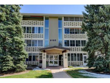 Inviting condominium with well-maintained landscaping and covered entrance in a serene residential area at 9180 E Center Ave # 9D, Denver, CO 80247