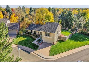 Inviting two-story home with well-manicured lawn and beautiful fall foliage at 7162 S Fillmore Cir, Centennial, CO 80122