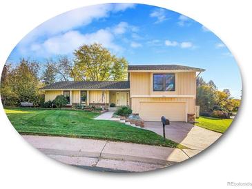 Charming home features a lush front yard, mature trees, and a welcoming entrance with an attached garage at 7162 S Fillmore Cir, Centennial, CO 80122