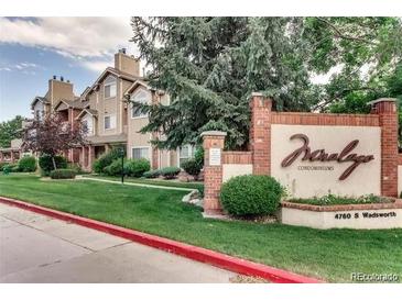 Charming condominium community with lush landscaping, a welcoming sign, and well-maintained exteriors at 4760 S Wadsworth Blvd # G304, Littleton, CO 80123