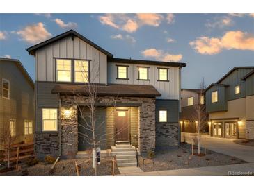 Charming two-story home with stone accents and professionally landscaped front yard at 23721 E 40Th Ave, Aurora, CO 80019
